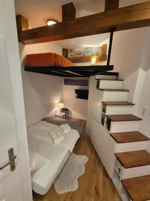 a room with two bunk beds and a staircase at The Hidden Echo Studio Kazimierz, #Netflix # AC# in Kraków