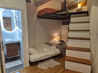 a bedroom with a bunk bed and a staircase at The Hidden Echo Studio Kazimierz, #Netflix # AC# in Kraków