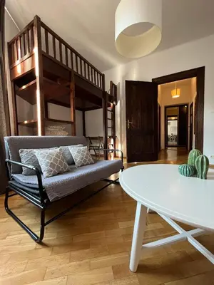 a living room with a bunk bed and a table at Apt for six in Kraków