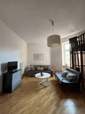 a living room with a couch and a table at Apt for six in Kraków