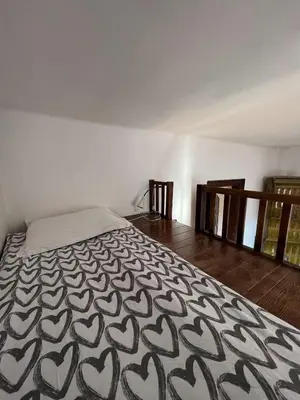 a bedroom with a bed with a black and white blanket at Apt for six in Kraków