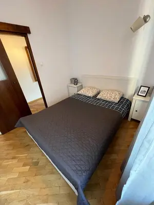a bedroom with two beds and two night stands at Apt for six in Kraków