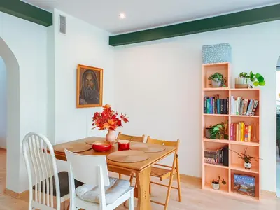 a dining room with a wooden table and chairs at Zwierzogród in Rabka