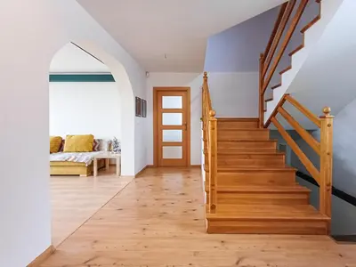 a hallway with a wooden staircase in a house at Zwierzogród in Rabka