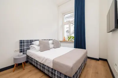 a small bedroom with a bed and a window at 1-bedroom apartment - Augustiańska 1 street in Kraków