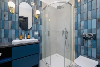 a bathroom with a shower with a sink and a toilet at 1-bedroom apartment - Augustiańska 1 street in Kraków