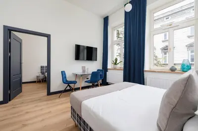 a bedroom with a bed and a table with chairs at 1 bedroom apartment - Augustiańska 1 in Kraków