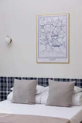 a bedroom with a bed with a map on the wall at 1 bedroom apartment - Augustiańska 1 in Kraków