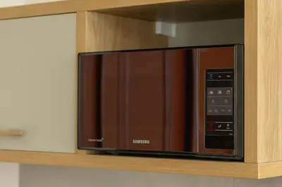 a microwave oven on a shelf in a kitchen at Cozy studio - Augustiańska 1 street in Kraków