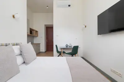 a bedroom with a bed and a table with a television at Studio for 2 - Augustiańska 1 - Kazimierz in Kraków