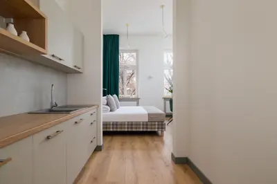 a kitchen with a bed in a room at 2-bedroom apartment - Augustiańska 1 street in Kraków