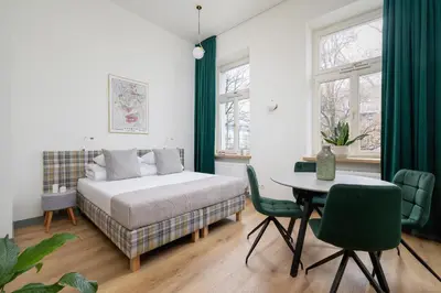 a bedroom with a bed and a table and chairs at 2-bedroom apartment - Augustiańska 1 street in Kraków
