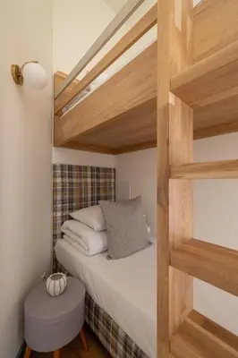 a bedroom with a bunk bed with a ladder at 2-bedroom apartment - Augustiańska 1 street in Kraków