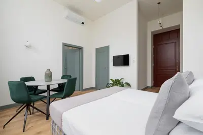 a bedroom with a bed and a table and chairs at 2-bedroom apartment - Augustiańska 1 street in Kraków