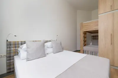 a bedroom with a white bed with pillows at 2-bedroom apartment - Augustiańska 1 street in Kraków