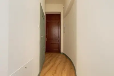 an empty hallway with a door and a wooden floor at Cozy apartment - Augustiańska 1 street in Kraków