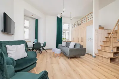 a living room with two couches and a table at Cozy apartment - Augustiańska 1 street in Kraków
