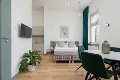 a living room with a bed and a table and chairs at Apartment for 6 people - Augustiańska 1 in Kraków