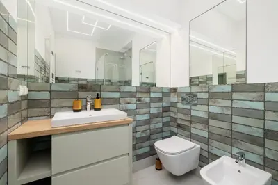 a bathroom with a toilet and a sink and mirror at Apartment for 6 people - Augustiańska 1 in Kraków