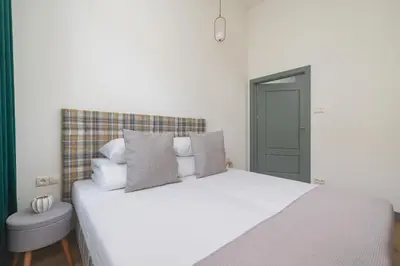 a bedroom with a large white bed with pillows at Apartment for 6 - Augustiańska 1 street in Kraków