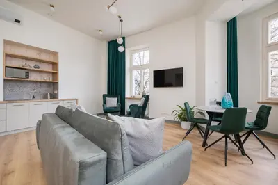 a living room with a couch and a table at Apartment for 6 - Augustiańska 1 street in Kraków