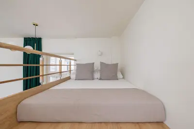 a white bedroom with a bed and a window at Apartment for 6 - Augustiańska 1 street in Kraków
