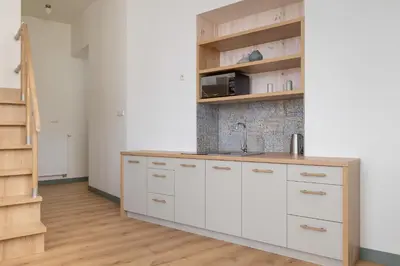 a kitchen with white cabinets and a sink at Apartment for 6 - Augustiańska 1 street in Kraków