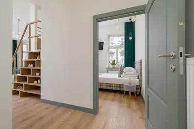 a door leading to a bedroom with a bed at Apartment for 6 - Augustiańska 1 street in Kraków
