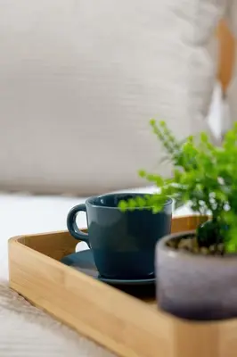 a blue coffee cup on a wooden tray with a potted plant at Klimatyzowany Apartament z Balkonem i Przestrzenią do Pracy Lokalizacja Blisko Wisły by Noclegi Renters in Kraków