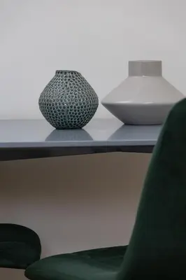 two vases sitting on a table with a green chair at Kazimierz- Augustiańska 1- Studio with AC in Kraków