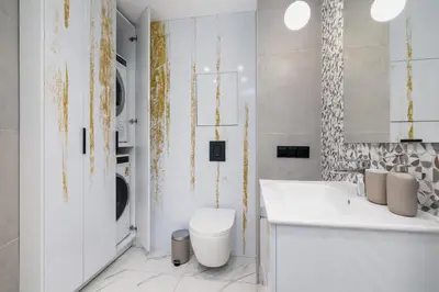a white bathroom with a toilet and a sink at Apartment with mezzanine - Augustiańska 1 in Kraków
