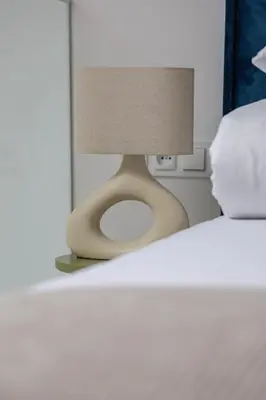 a lamp sitting on top of a bed at Apartment with AC- Augustiańska 1 in Kraków