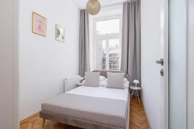 a small bedroom with a bed and a window at 2 Bedroom apartment with AC - Augustiańska 1 in Kraków