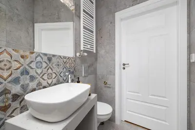 a bathroom with a white sink and a toilet at 2 Bedroom apartment with AC - Augustiańska 1 in Kraków