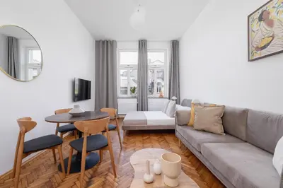 a living room with a couch and a table at 2 Bedroom apartment with AC - Augustiańska 1 in Kraków
