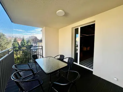 a balcony with a table and chairs on a balcony at Urban Chic Panorama - Design Apartaments in Kraków