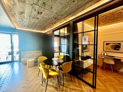 a living room with a table and yellow chairs at Urban Chic Panorama - Design Apartaments in Kraków