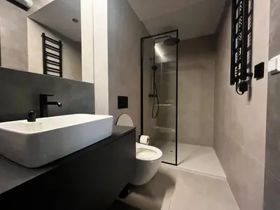 a bathroom with a sink and a toilet and a shower at Urban Chic Panorama - Design Apartaments in Kraków