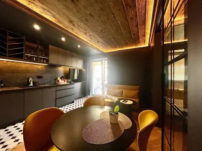 a kitchen with a table and chairs in a room at Urban Chic Panorama - Design Apartaments in Kraków