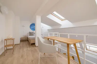 a dining room with a table and a couch at Modern Loft apartment -Kazimierz district in Kraków