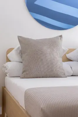 a bed with a bunch of pillows on it at Modern Loft apartment -Kazimierz district in Kraków
