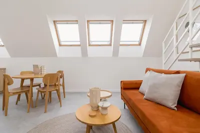 a living room with a couch and a table at Modern Loft apartment -Kazimierz district in Kraków