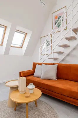 a living room with a couch and a table at Modern Loft apartment -Kazimierz district in Kraków