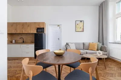 a living room with a table and chairs and a couch at Kazimierz Area - Augustiańska 1 street in Kraków
