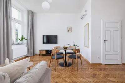 a living room with a table and a couch at Kazimierz Area - Augustiańska 1 street in Kraków