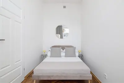 a bedroom with a bed with white walls at Kazimierz Area - Augustiańska 1 street in Kraków