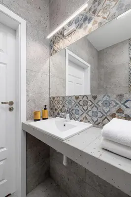 a bathroom with a sink and a mirror at Kazimierz Area - Augustiańska 1 street in Kraków