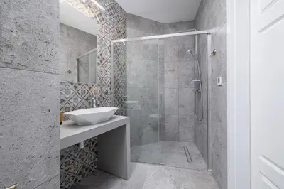 a bathroom with a glass shower and a sink at 2 Bedroom Apartment for 6 - Augustiańska 1 street in Kraków