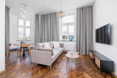 a living room with a couch and a table at 2 Bedroom Apartment for 6 - Augustiańska 1 street in Kraków