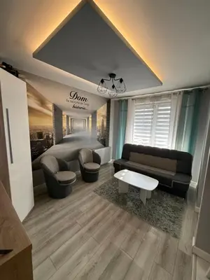 a living room with a couch and a table at Mieszkanie z parkingiem podziemnym Przewóz Podgórze in Kraków
